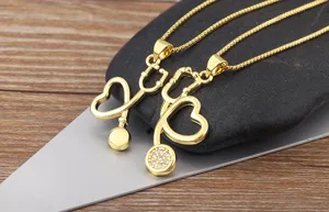 Close up detail shot of golden stethoscope pendant necklace with sparkling stone accents.