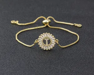 Gold plated 18k initial letter T adjustable slider bracelet with round cubic zirconia charm.