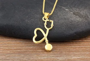 Gold plated stethoscope pendant necklace, medical heart jewelry detail view for daily wear.