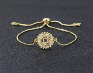 Detailed close-up of a gold-plated adjustable bracelet featuring a sparkling zircon letter D.