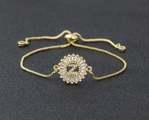 Adjustable gold plated letter Z tennis bracelet with micro pave cubic zirconia round pendant for women.