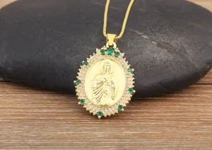 Gold plated religious pendant necklace with green and white cubic zirconia stones.