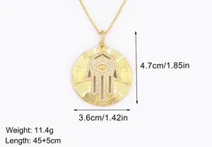 Gold plated Hamsa hand pendant necklace with cubic zirconia evil eye design, elegant and stylish.