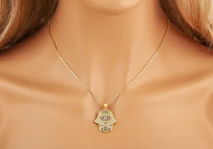 Gold-plated Hamsa hand pendant necklace with colorful cubic zirconia stones detailing.