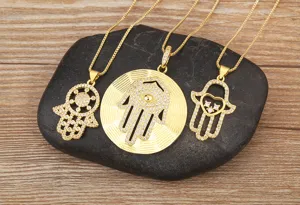 Gold plated Hamsa hand pendant necklace close-up, delicate cubic zirconia detail, shiny jewelry.