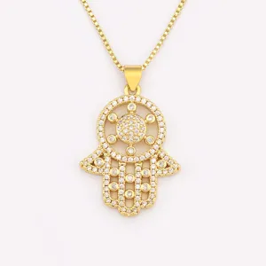 Gold plated hamsa hand evil eye pendant necklace for women, stylish cubic zirconia jewelry.