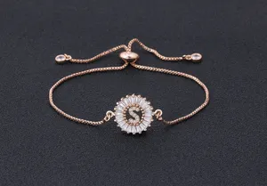 Closeup of rose gold adjustable letter S bracelet with micro-paved sparkling cubic zirconia.