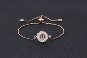 Close-up detail of a rose gold letter U pendant bracelet with micro-set cubic zirconia.
