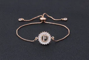 Detailed view of rose gold adjustable letter F bracelet with sparkling cubic zirconia stones.