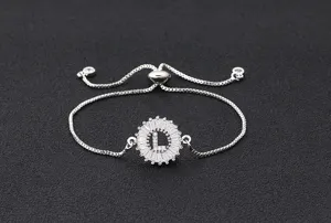 Detail of silver adjustable letter bracelet featuring a sparkling paved cubic zirconia round pendant.