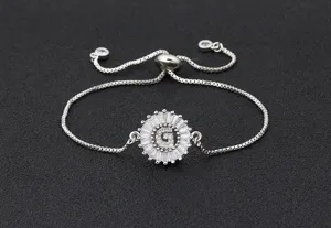 Close-up detail of silver initial G sunburst zircon adjustable slider bracelet jewelry.