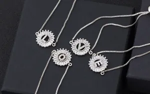 Detail close-up of adjustable silver-tone micro-pave cubic zirconia letter bracelets LOVE.