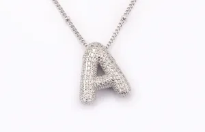 Close-up detail of the silver 3D balloon letter A pendant necklace with sparkling zirconia.