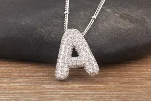 Close-up of a sparkling silver bubble letter A pendant necklace with tiny cubic zirconia stones.