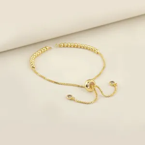 Adjustable gold slider bead bracelet extension chain details, delicate jewelry accessory.