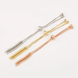 Detail view of adjustable slider extension chains with beads in silver, gold, and rose gold.