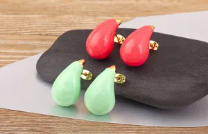 Close-up detail shot of colorful teardrop enamel stud earrings with 18k gold plated finish.