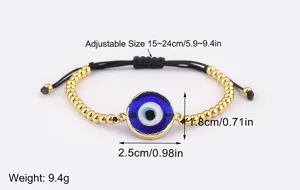 Bracelet à breloque mauvais œil plaqué or avec cordon noir réglable et perle bleue.