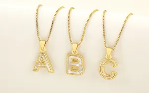 Gold plated natural mother of pearl initial letter pendant necklace closeup detail shot.