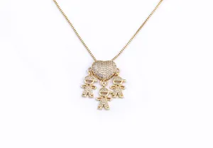Gold plated sparkling crystal heart necklace with three boy pendants detail closeup.