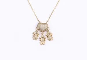 Detailed view of 18k gold plated necklace with glittering rhinestone heart and three girls charms.