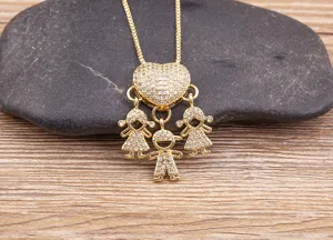 Detailed view of 18k gold plated family children pendant necklace with sparkling stones.