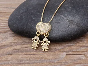 Gold plated heart necklace detail showing double girl pendant with cubic zirconia stones.