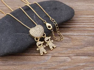 Gold plated family boy pendant necklace with sparkling cubic zirconia heart charm detail.