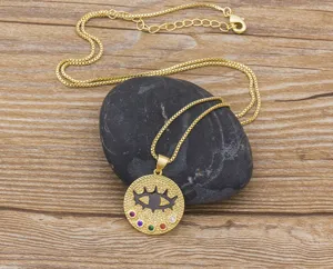 Detail view of gold chain necklace featuring evil eye pendant with colorful zircon stones.