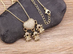 Gold-plated heart pendant necklace with three sparkling girl charms, elegant family gift.