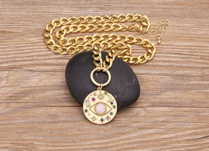 Primo piano della collana con ciondolo malocchio placcata in oro con zirconi colorati e catena.