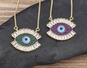 Gold tone evil eye pendant necklace with colorful sparkling cubic zirconia crystal stones.