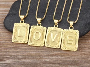 Details of the gold letter necklace featuring 4 rectangular pendants with embossed LOVE letters.