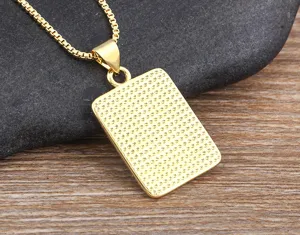 Detailed view of a golden rectangular pendant necklace with a stylish textured design for men.