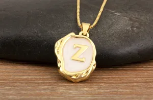 Gold plated initial Z pendant necklace with white enamel and irregular geometric design.