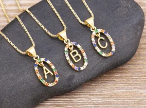Close up shot of colorful cubic zirconia initial letter pendant necklace delicate details.
