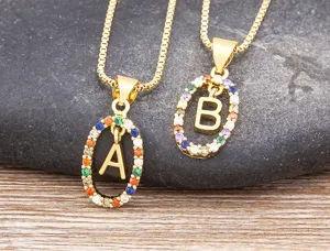 Gold initial letter pendant necklace with colorful cubic zirconia stones, elegant chain.