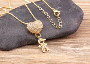 Gold tone heart and boy pendant necklace detail shot showcasing brilliant pave crystal decor.