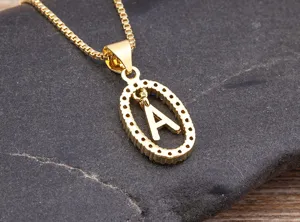 Close-up detail of a gold-plated letter A pendant necklace adorned with colorful zirconia stones.