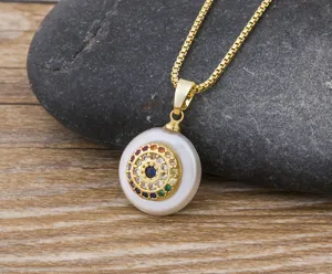 Detailed close-up of a gold-plated evil eye pendant necklace featuring colorful cubic zirconia.