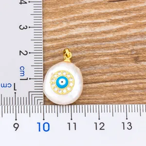 Baroque pearl evil eye pendant necklace with sparkling cubic zirconia in gold tone.