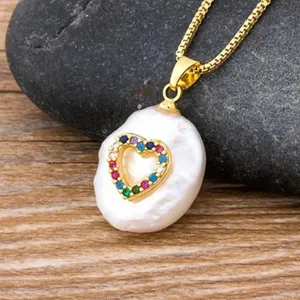 Exquisite baroque pearl necklace featuring a colorful zircon heart pendant on gold chain.