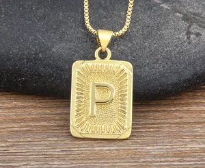 Men gold letter pendant necklace with rectangular initial charm and metal box chain detail.