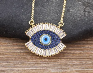 Detailed shot of a gorgeous Turkish evil eye pendant necklace in gold with blue and white stones.