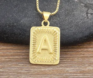 Close-up of a gold-plated hip-hop letter A pendant necklace with textured border detail.