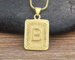 Close up view of gold letter B pendant necklace, hip hop style initial chain for men.
