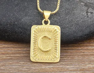 Detail view of a stylish gold letter C pendant necklace with a classic box chain for men.