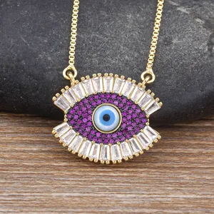 Trendy Turkish evil eye pendant necklace featuring purple and white stones, gold chain.