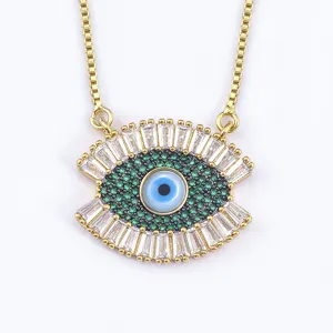 Gold evil eye necklace pendant with green and clear cubic zirconia crystal stones for women.