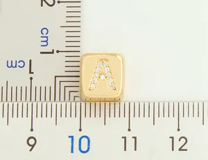 Gold plated cubic zirconia letter A pendant charm detail with size reference scale.